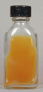 Photograph of an uninoculated flask of dermatophyte test medium (DTM) showing its initial acidic pH (Phenol red is yellow).